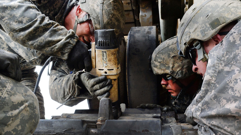 US Army personnel using a Roboimpact on heavy machinery