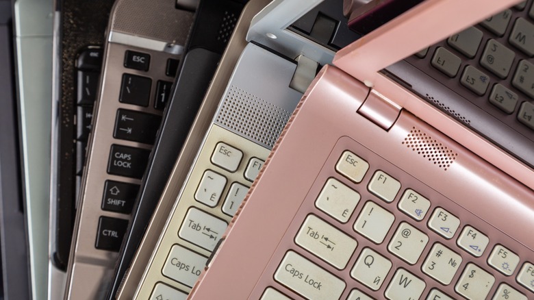a stack of used laptops slated for refurbishment