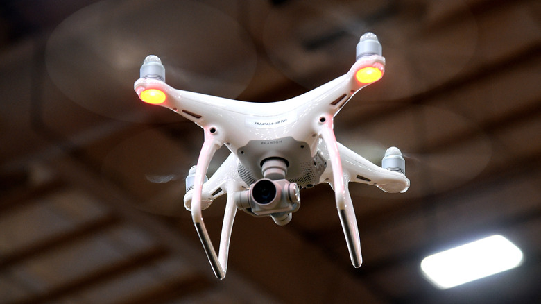 Picture of the DJI Phantom 4 in the air, with its status lights activated
