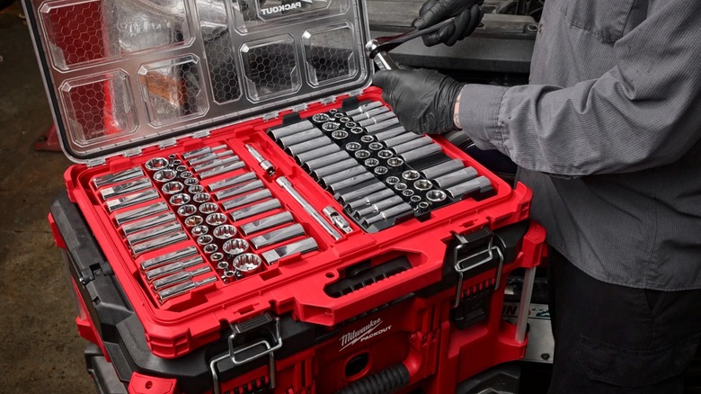 A Milwaukee Tool socket set in use by a mechanic.