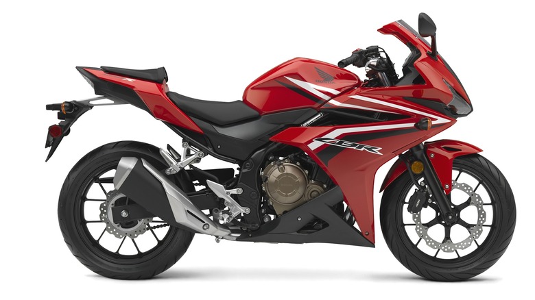 A bold red Honda CBR500R looking sleek and ready to ride with a white background.