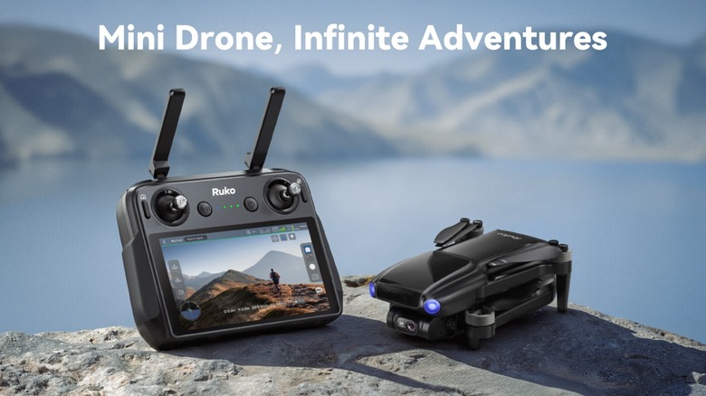 Ruko U11MINI 4K drone with independent controller system resting on a rock on mountainous lakeside terrain. There is a caption that says 