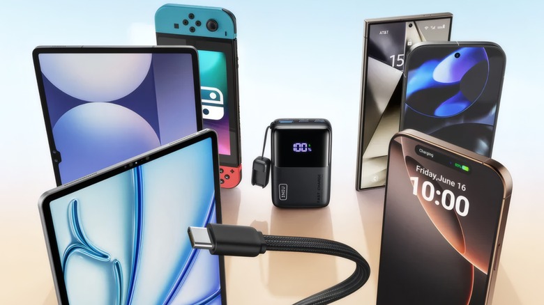 Iniu power bank surrounded by smartphones, tablets, and a Nintendo Switch