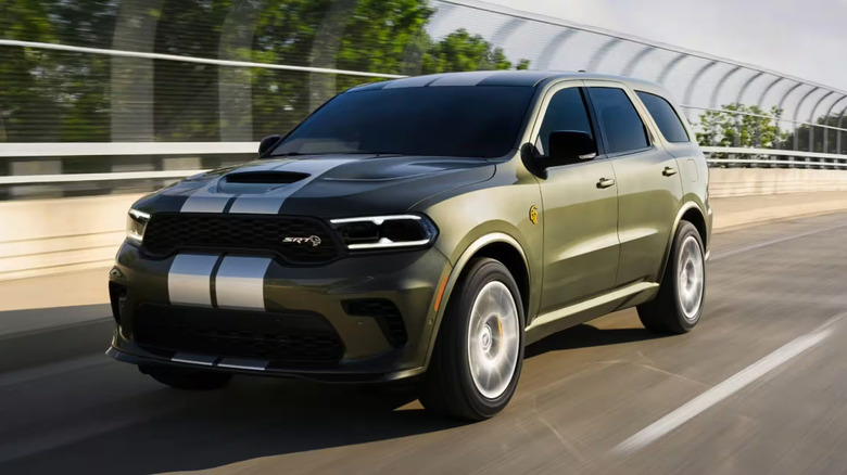 A green Dodge Durango cruising on a highway