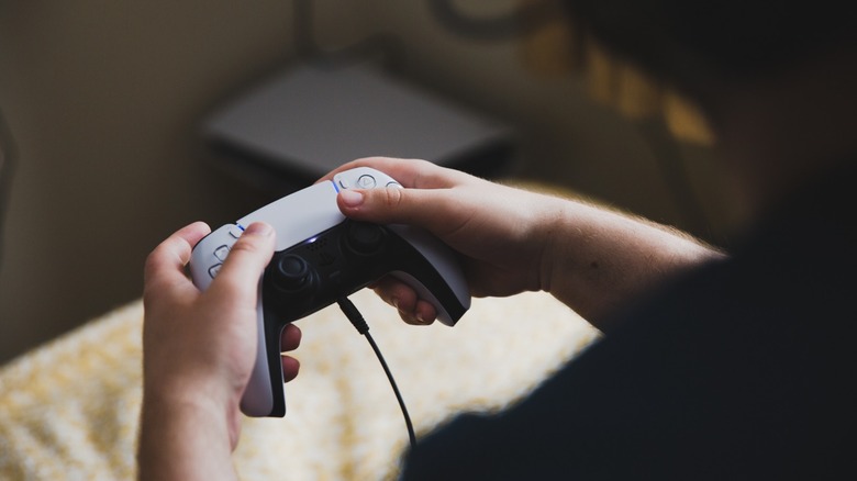 Person using a PS5 controller