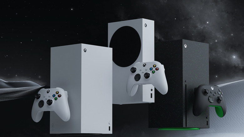 Three Xbox Series consoles displayed with matching controllers in white and black models.