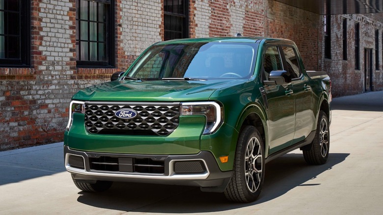 Green 2025 Ford Maverick parked in front of a brick building