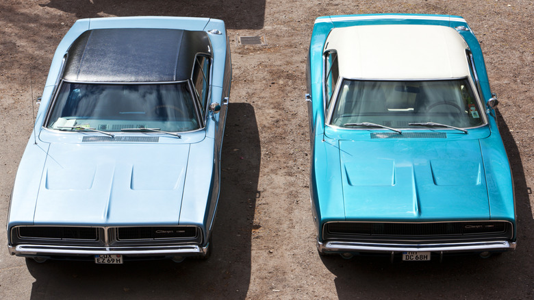 Two vintage Dodge Charger muscle cars pictured from above.