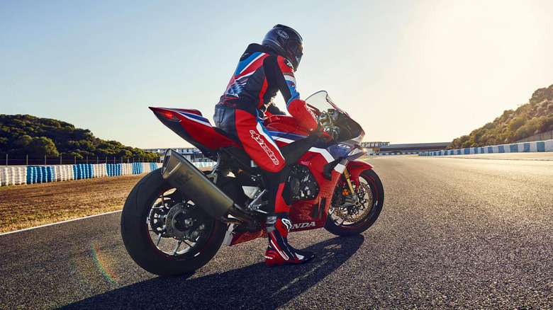 Person with their foot down while straddling a Honda CBR-1000RR-R Fireblade SP