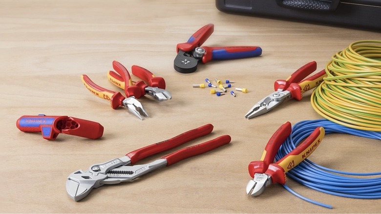 A set of Knipex pliers on a table with blue and yellow electrical wire
