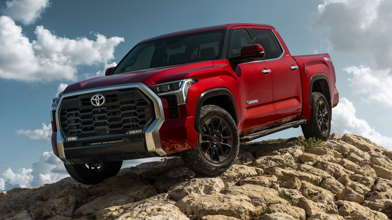 Red Toyota Tundra parked on a rocky incline