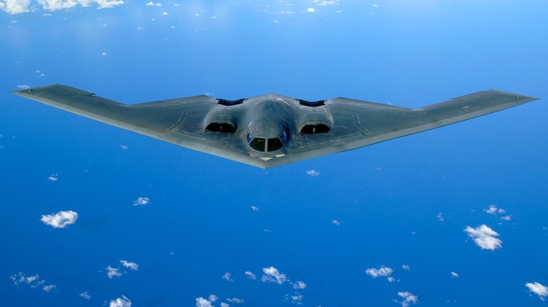 A B-2 Spirit flying over blue skies