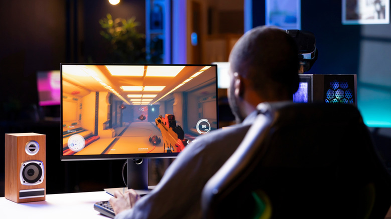 Man playing PC games at a desk