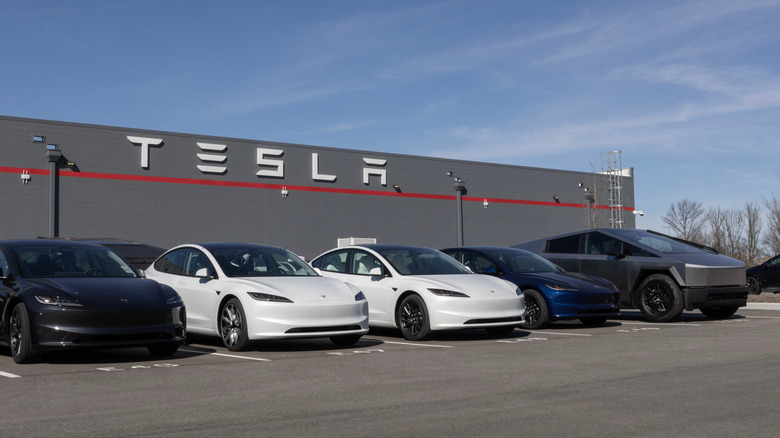 Tesla cars parked in front of a Tesla building