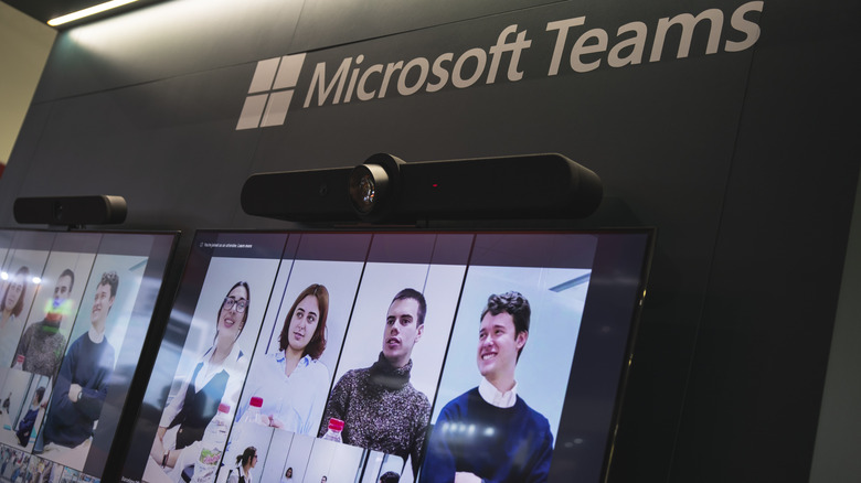 A Microsoft Teams meeting shown on screens.