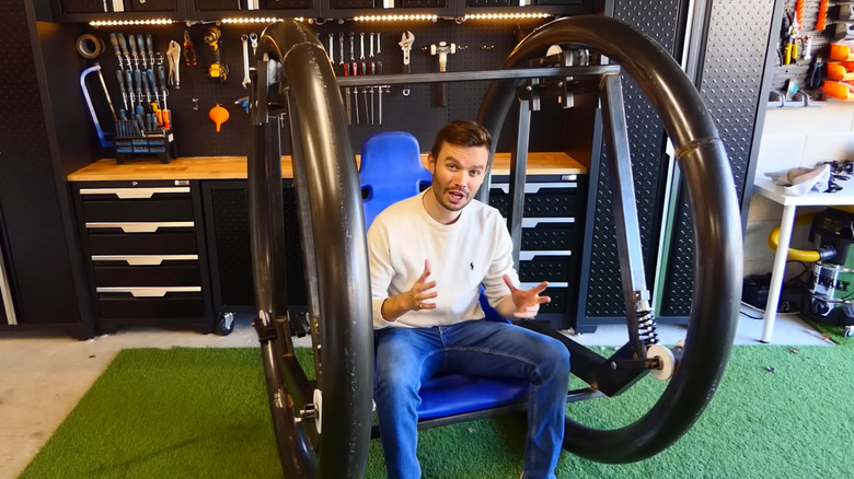 Sam Barker in garage sitting in partially-built diwheel