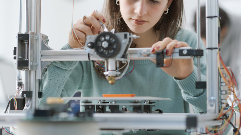 A person using a 3D printer.