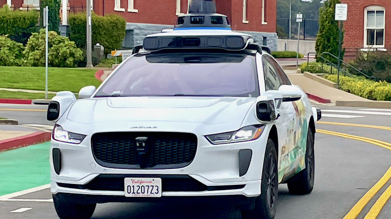 A Waymo autonomous vehicle driving towards the camera.
