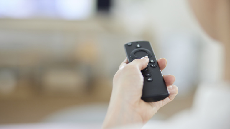 Person using Fire TV Stick remote