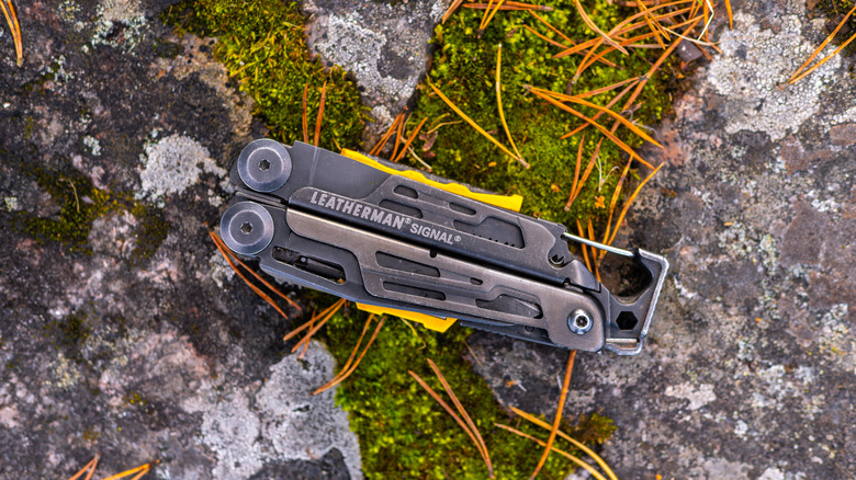 Leatherman Signal multi-tool on a mossy rock