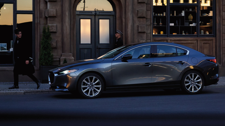 Gray Mazda3 sedan parked on street, side view