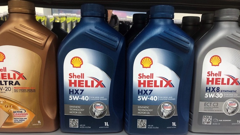 A selection of Shell Helix oil bottles on a store shelf.