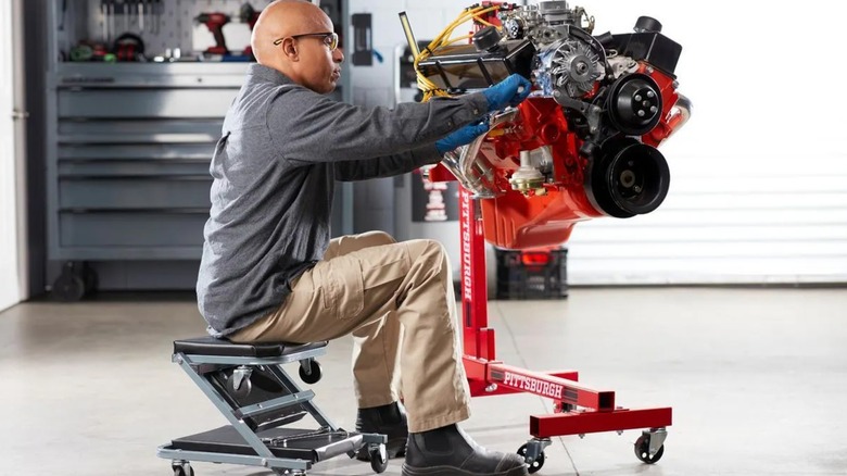 mechanic using Pittsburgh Z-Creeper to perform engine maintenance