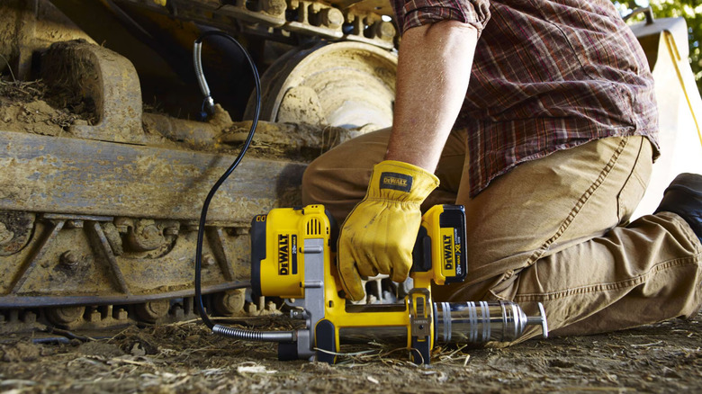 DeWalt 20V Max grease gun in use.