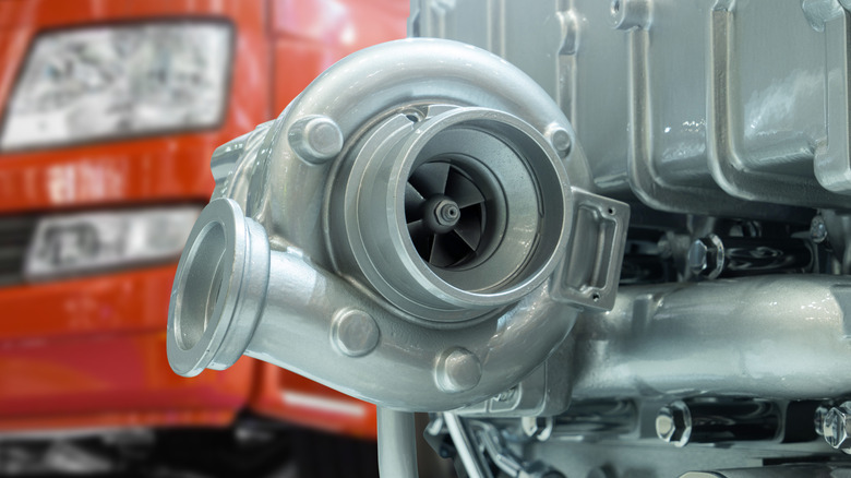 Close-up of a turbocharger mounted on the right-side of a truck engine