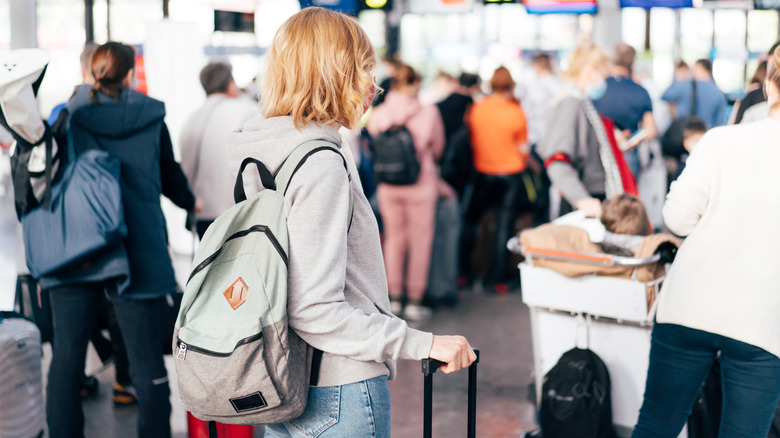 woman waiting in security line at airport
