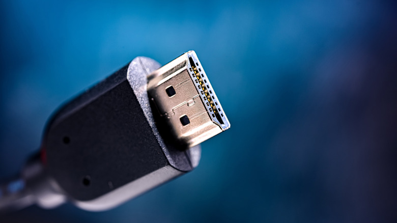 Close up of an HDMI connector against a blue background