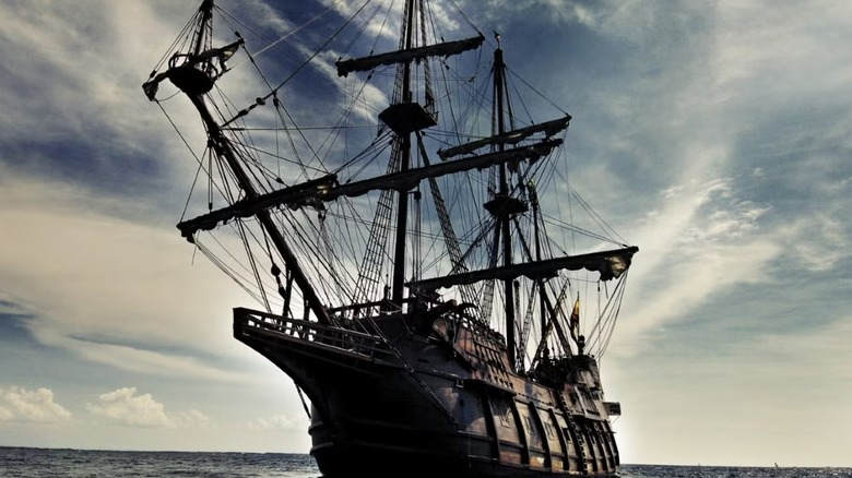 The Black Pearl on the water with its sails up