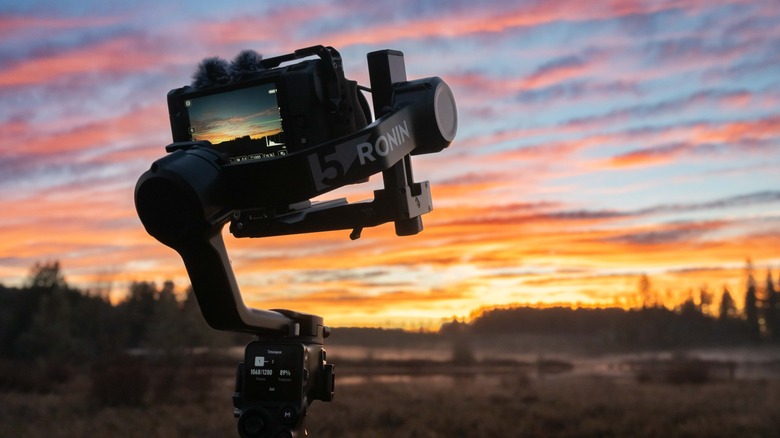 The DJI Ronin 5 carrying a camera with a sunset in the background.