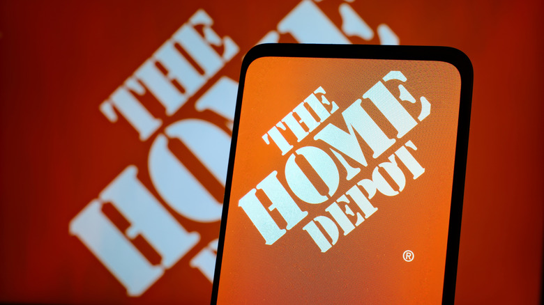 Picture showing The Home Depot logo on mobile device and background