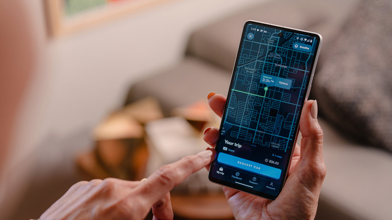 A rider books a Waymo ride on the app on their phone