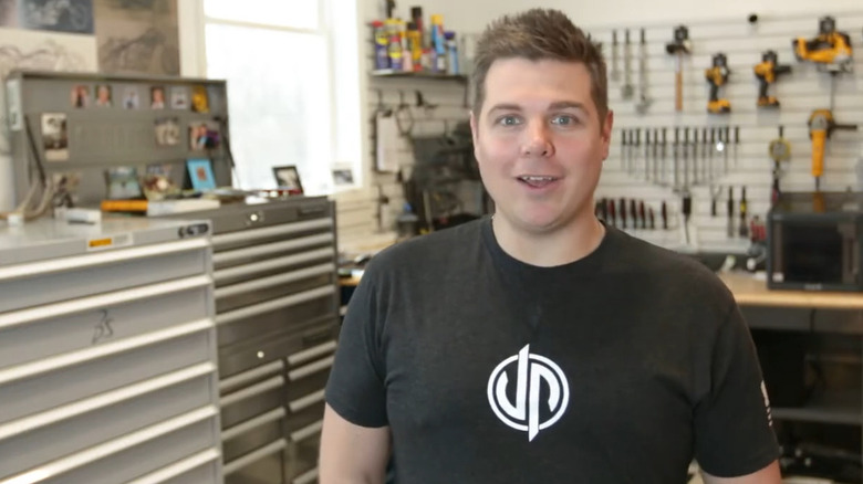 Jason Pohl smiling and talking in shop