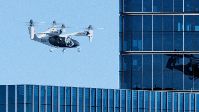 Joby flying next to buildings
