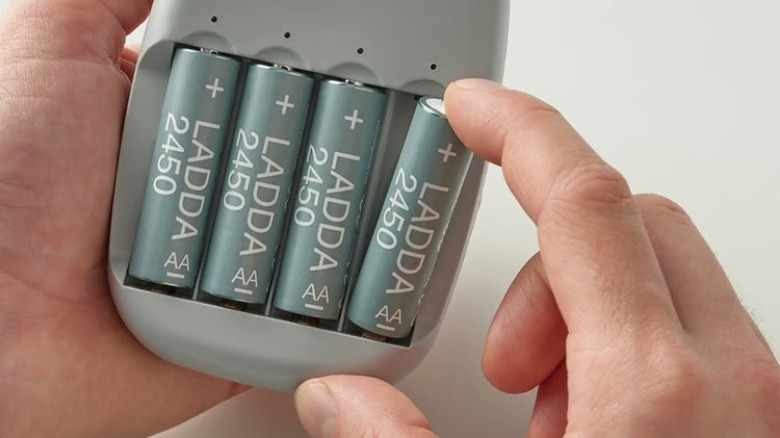 Hand holding a Ladda battery charger