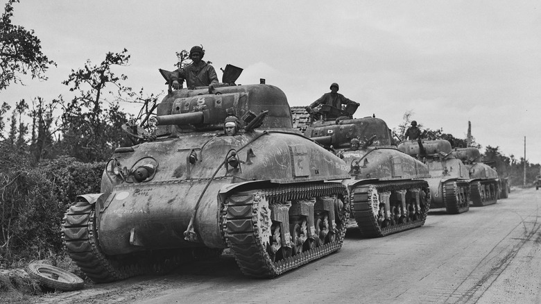 Line of Sherman tanks on road during World War II