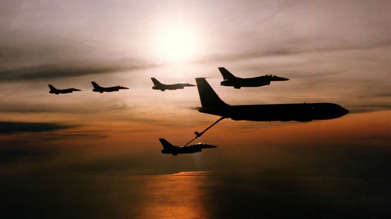 Silhouette of a KC Stratotanker refueling an F-16.