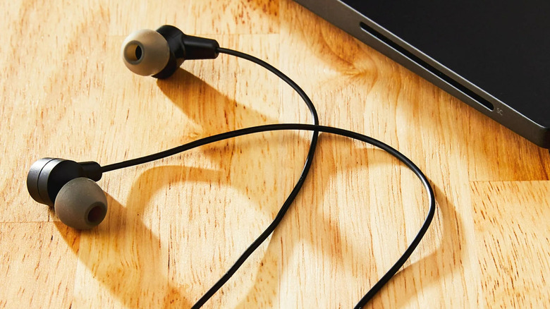 Onn brand earbuds on wooden desk