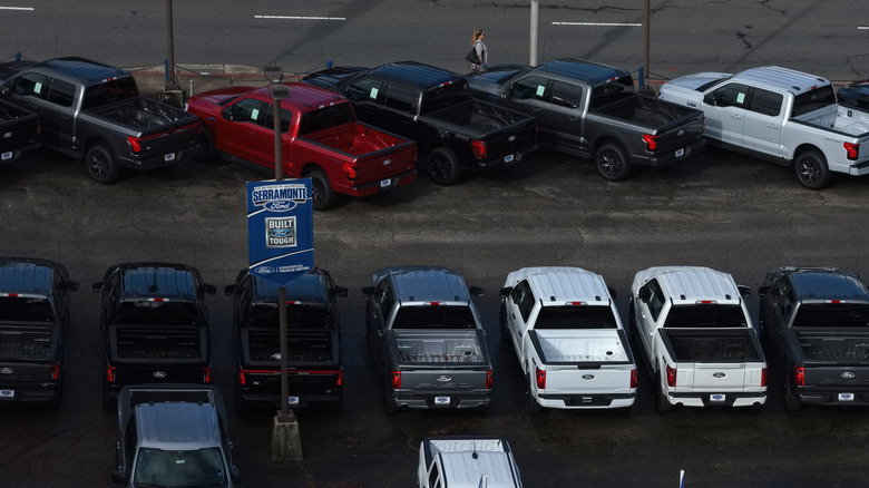 Several pick up trucks in a parking lot