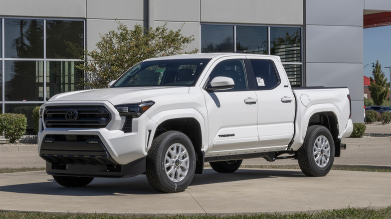Red 2018 Toyota Tacoma with a few inches of snow on top of it