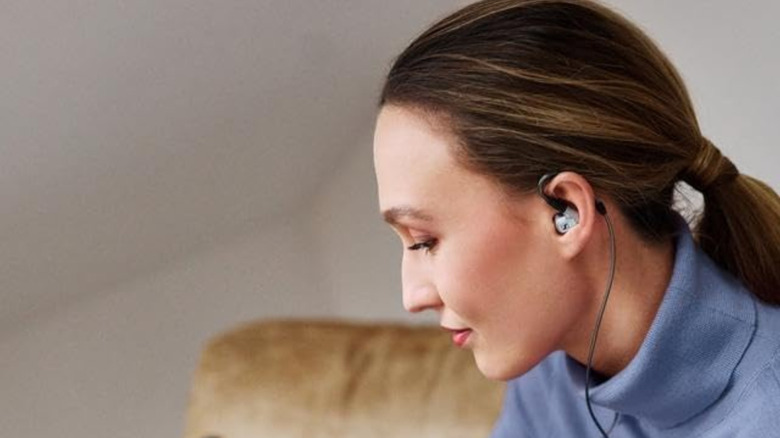 A person wearing the Sennheiser IE 900 IEMs