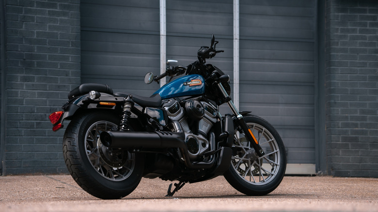The side view of a dark Harley-Davidson Nightster motorcycle, photographed from low-down on the right.
