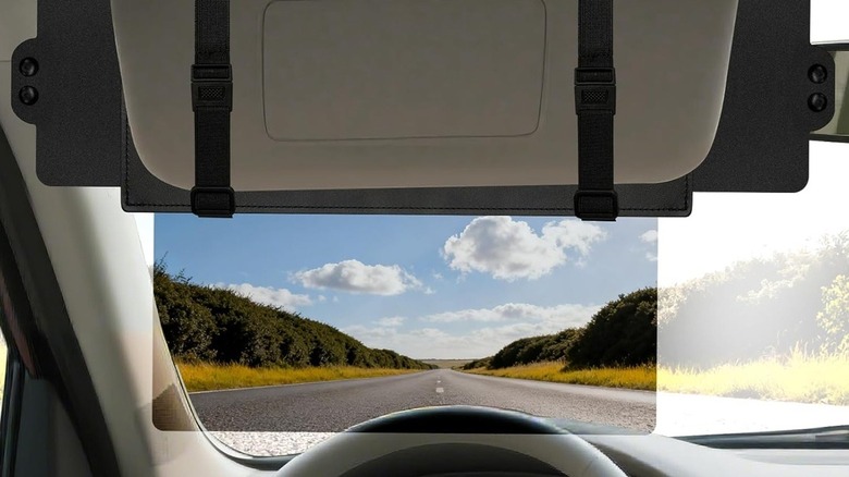 A transparent polarized car visor mounted on a regular sun visor.