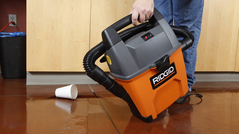 Man using a Ridgid handheld wet/dry vac