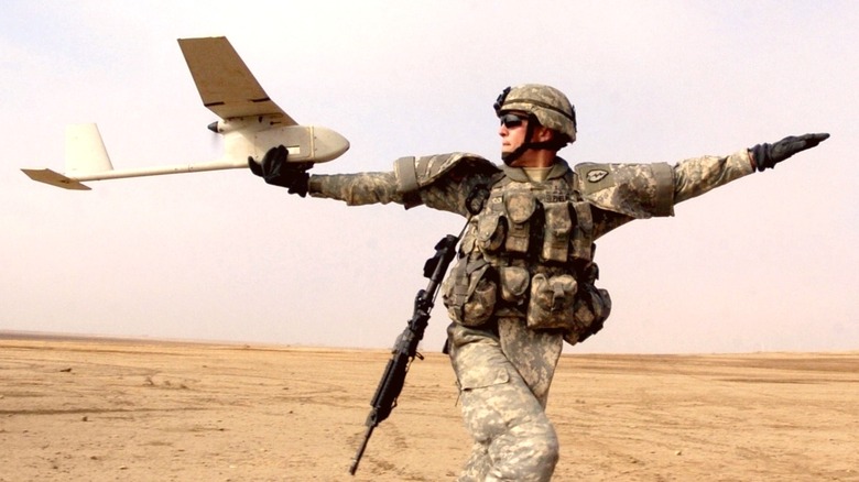 A soldier launching an RQ-11 Raven in Iraq