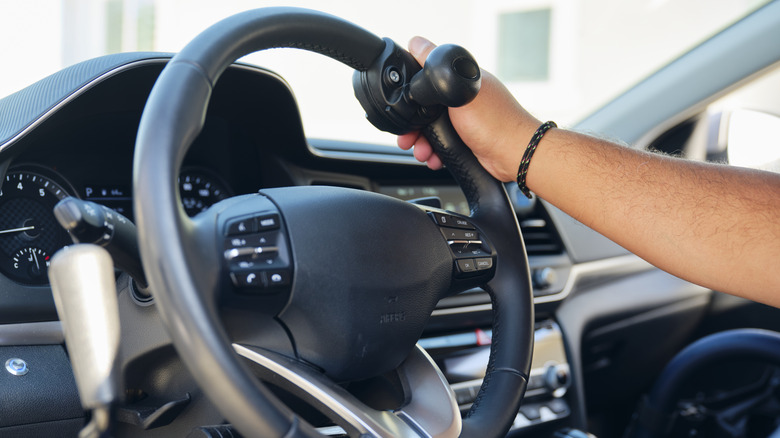 A steering knob on a black steering wheel