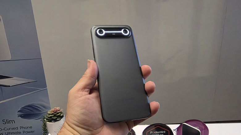 Man holding a Tecno Pova Slim